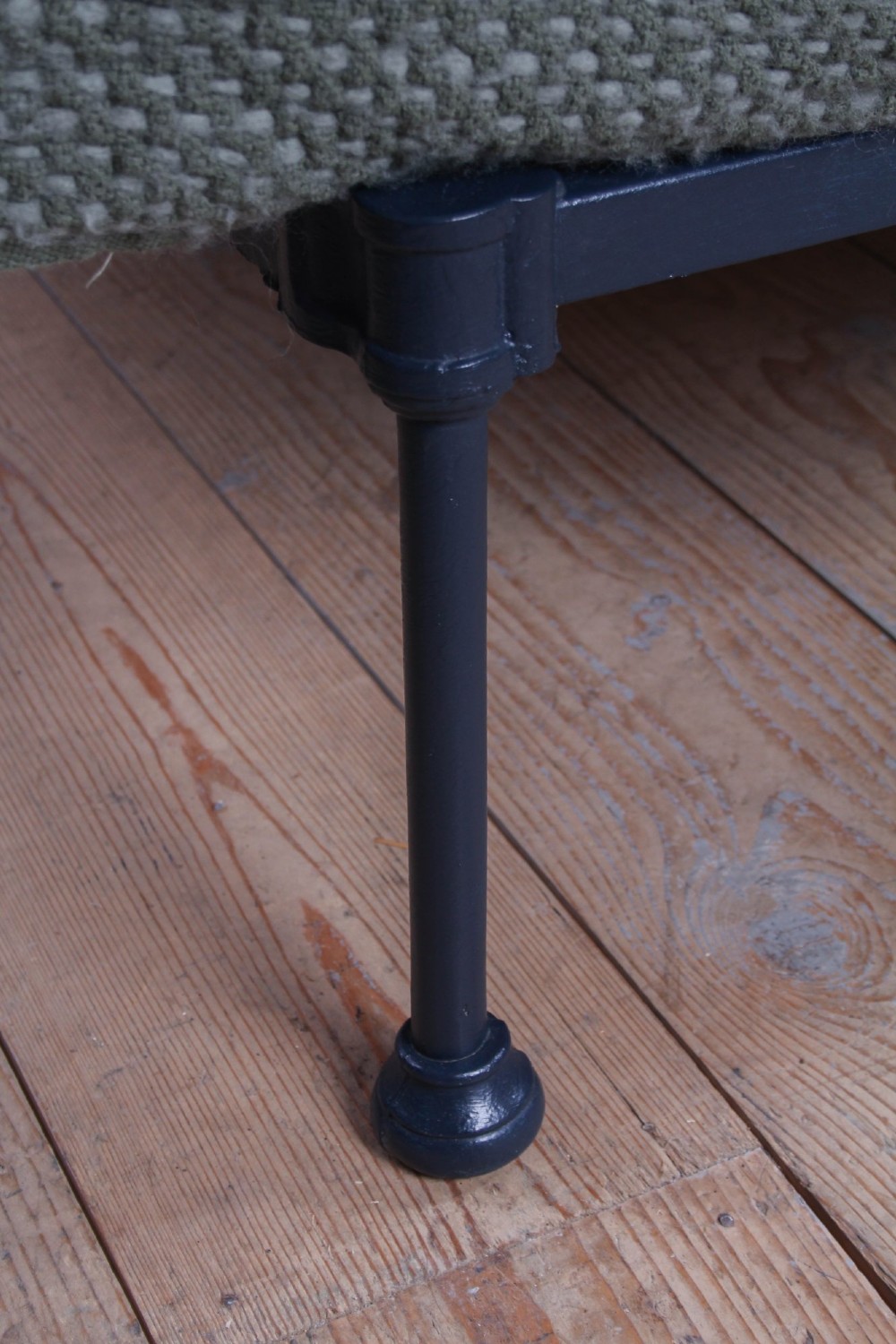 A Victorian double bed frame featuring a dark cast iron headboard with vertical spindles and a polished brass top rail with corner finials. View V