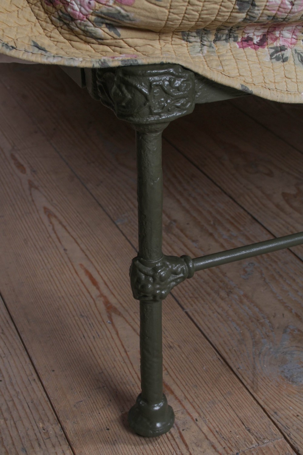 Victorian dark green cast iron double bedstead featuring an arched headboard with decorative scrollwork and a low foot end. View IV