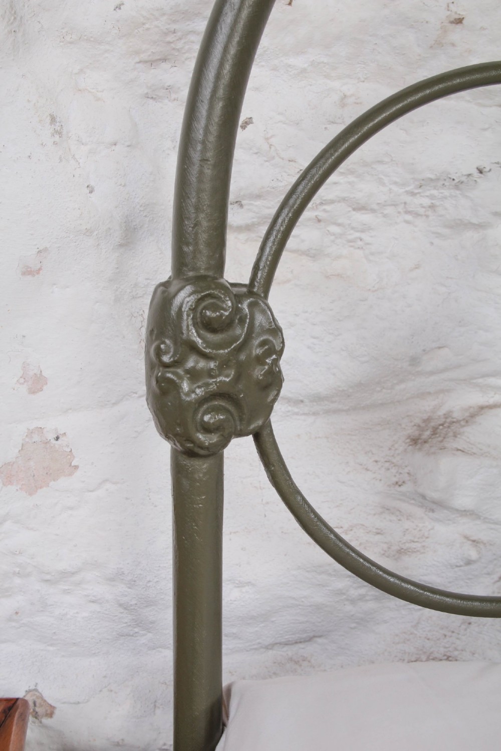 Victorian dark green cast iron double bedstead featuring an arched headboard with decorative scrollwork and a low foot end. View VII