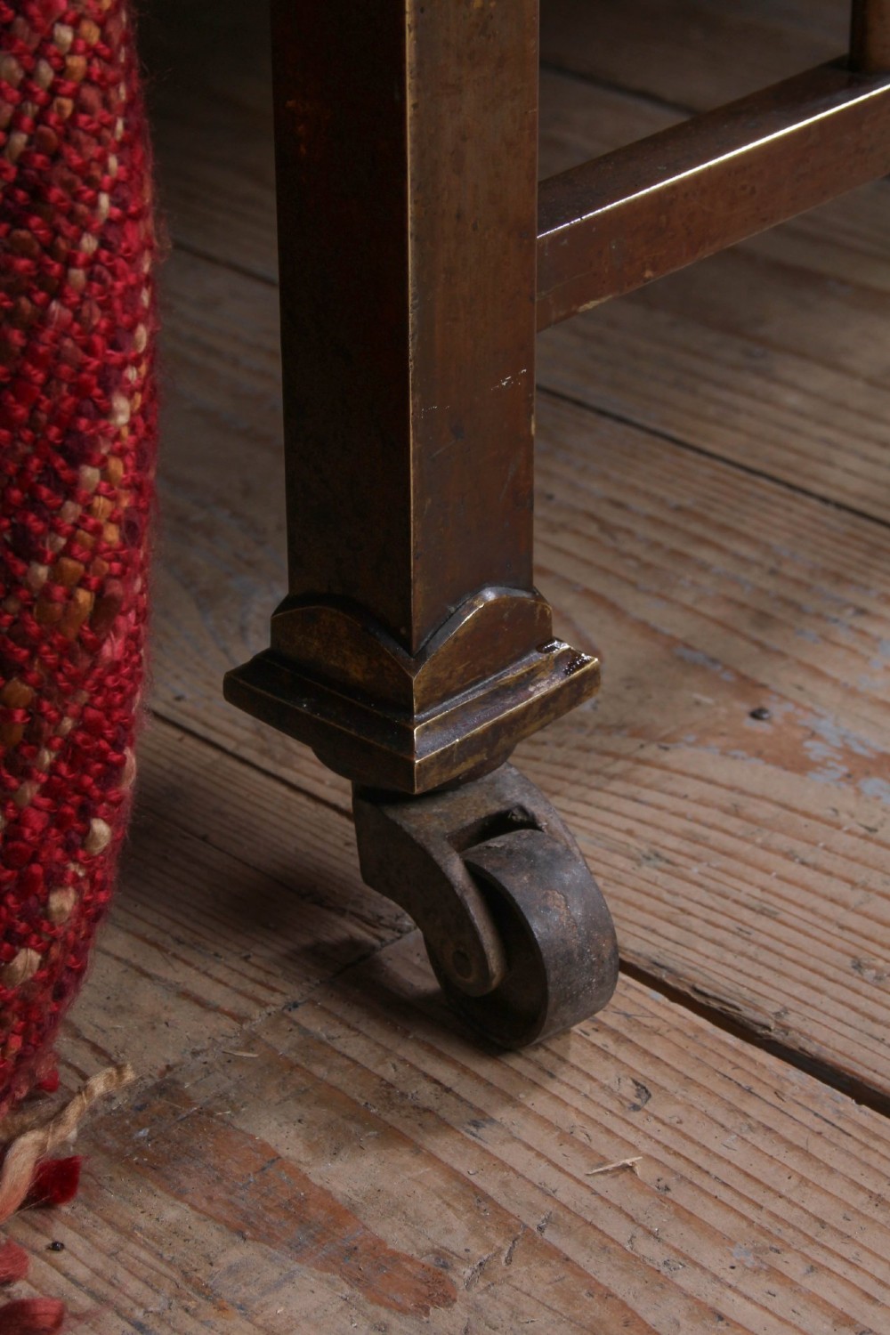 An antique French double bed constructed from brass tubing featuring a curved top rail, vertical spindles, ball finials, and original castors. View IV