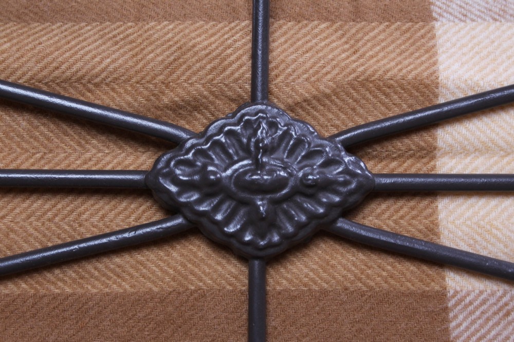A Victorian dark iron king-size bedstead featuring geometric cross-bracing and cast decorative joints on the headboard and footboard. View IV