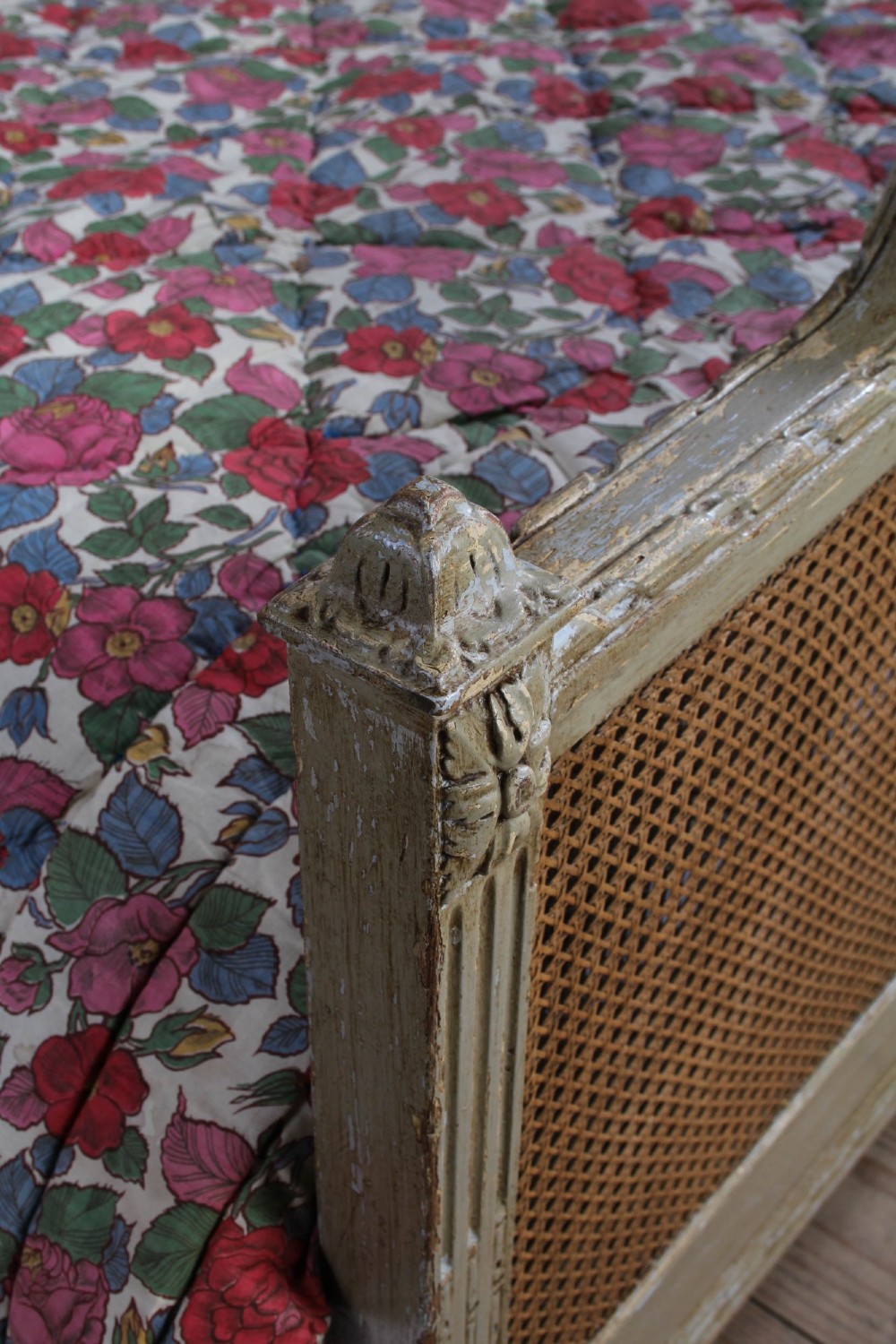A French Louis XVI style double bed frame with a carved wood surround, woven cane headboard and footboard, fluted legs, and a distressed grey painted finish. View III