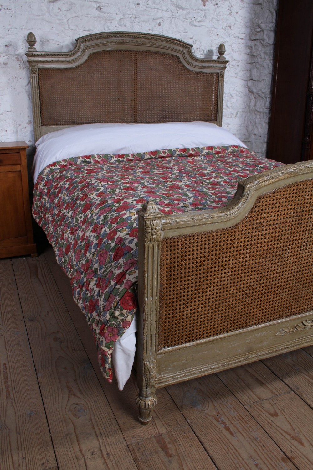 A French Louis XVI style double bed frame with a carved wood surround, woven cane headboard and footboard, fluted legs, and a distressed grey painted finish. View V