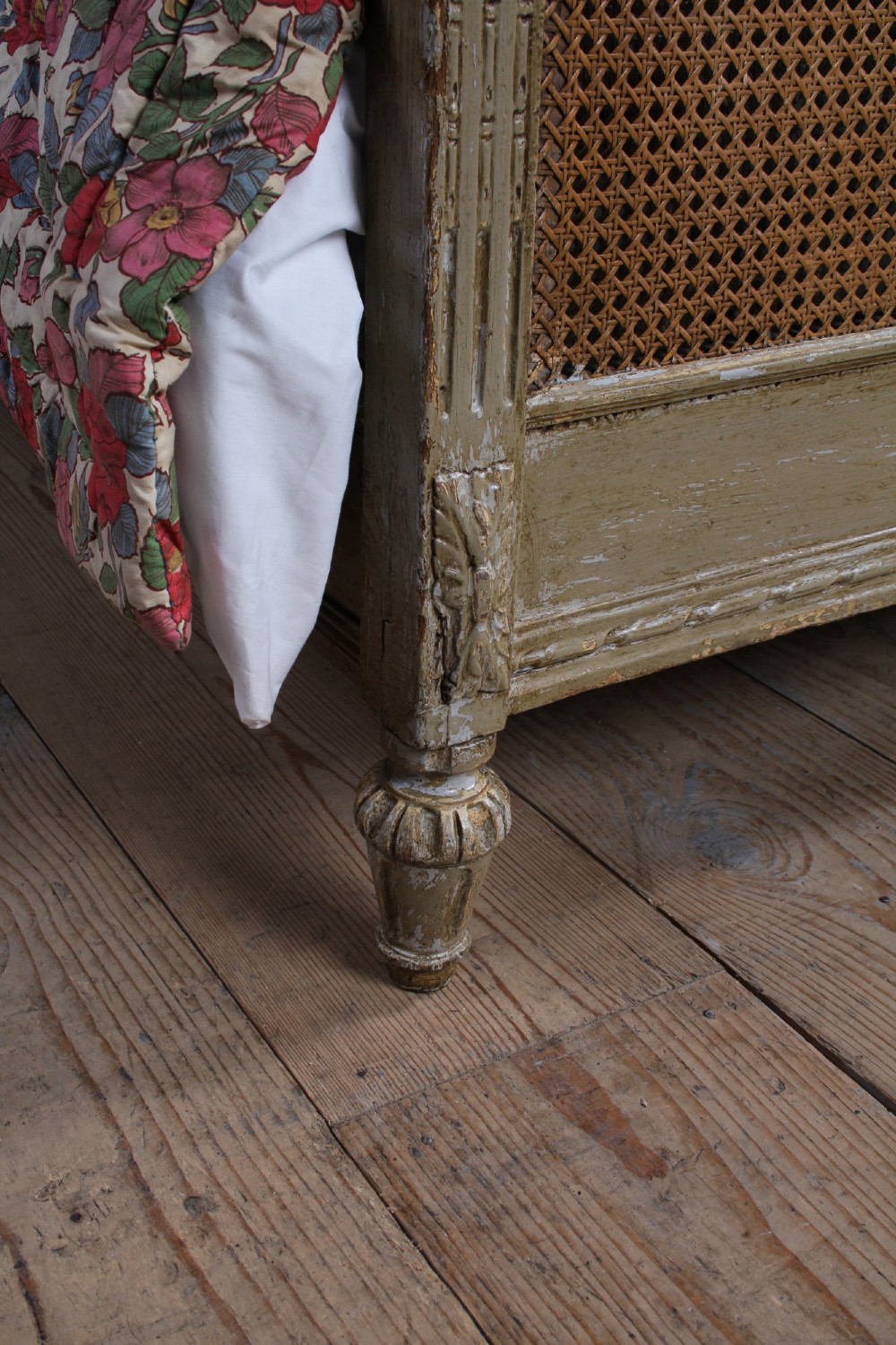 A French Louis XVI style double bed frame with a carved wood surround, woven cane headboard and footboard, fluted legs, and a distressed grey painted finish. View VIII