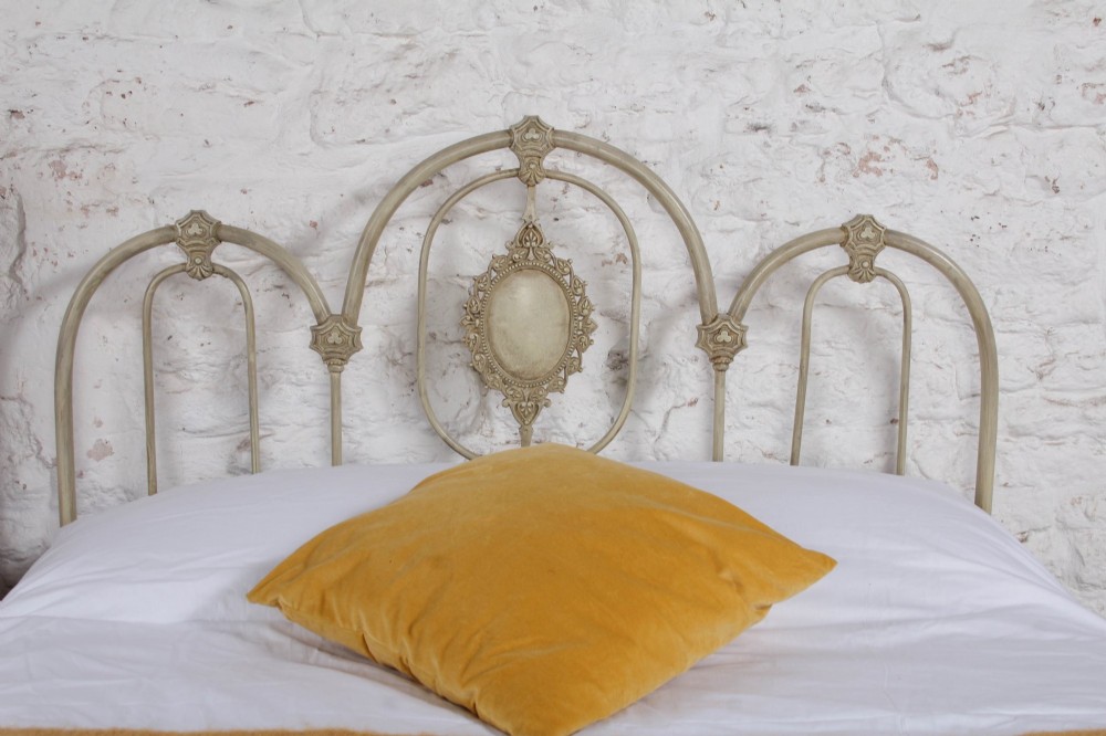 A Victorian cream-painted iron double bed frame featuring a three-hoop headboard and footboard design with central ornate medallions. View III