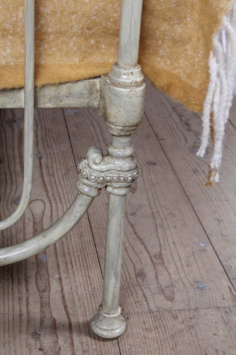 A Victorian cream-painted iron double bed frame featuring a three-hoop headboard and footboard design with central ornate medallions. View VI