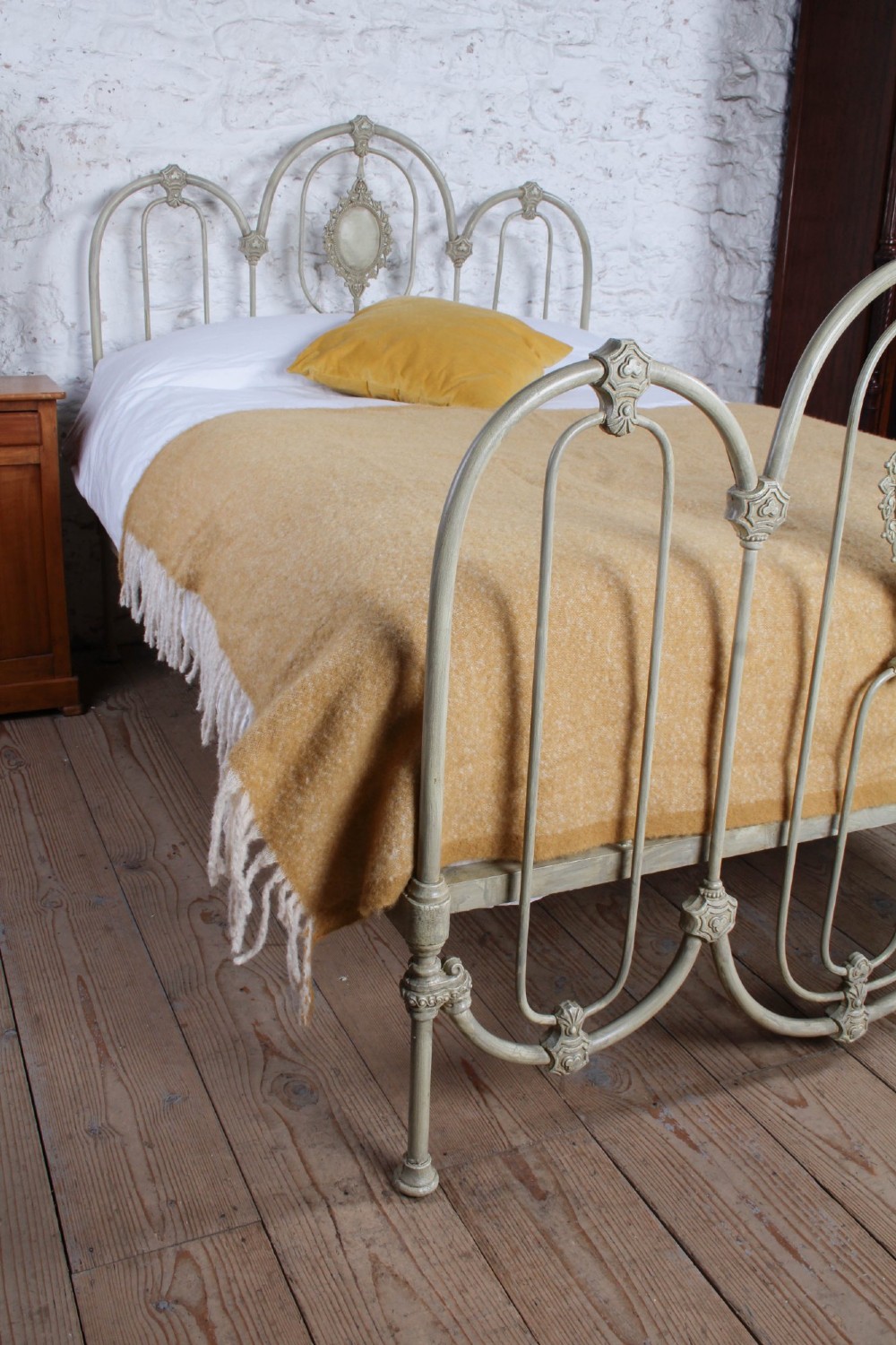 A Victorian cream-painted iron double bed frame featuring a three-hoop headboard and footboard design with central ornate medallions. View VII