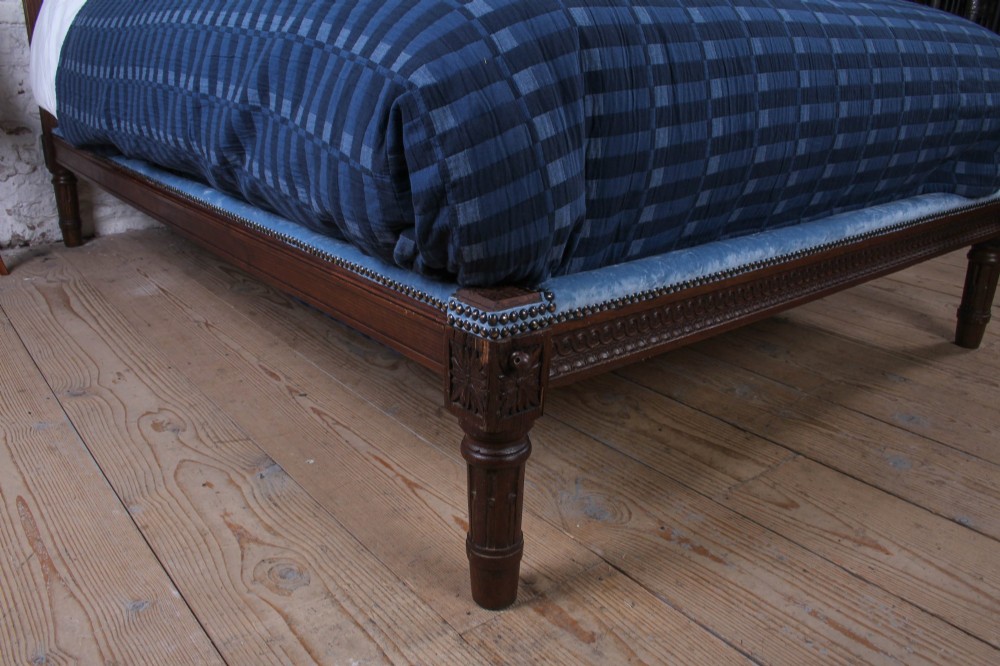 A Louis XVI style oak double bed frame featuring an arched headboard and low footboard upholstered in light blue fabric with trim details. View II