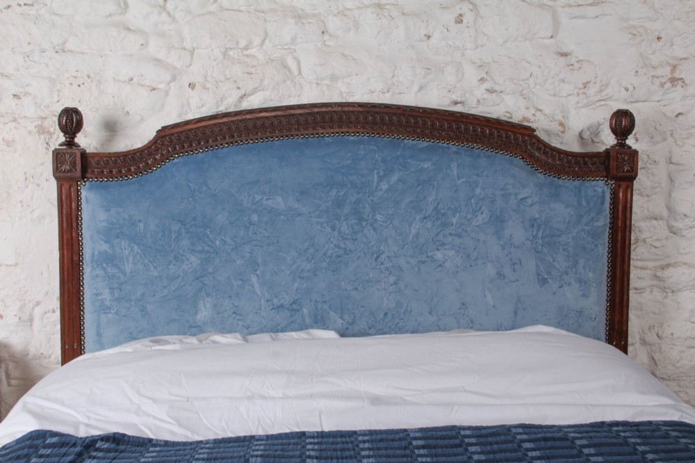 A Louis XVI style oak double bed frame featuring an arched headboard and low footboard upholstered in light blue fabric with trim details. View V