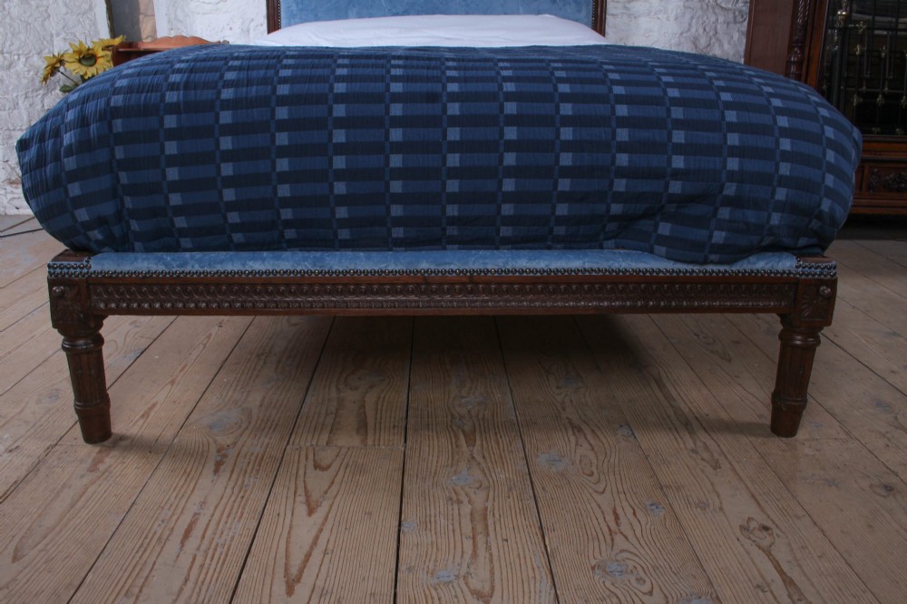 A Louis XVI style oak double bed frame featuring an arched headboard and low footboard upholstered in light blue fabric with trim details. View VII