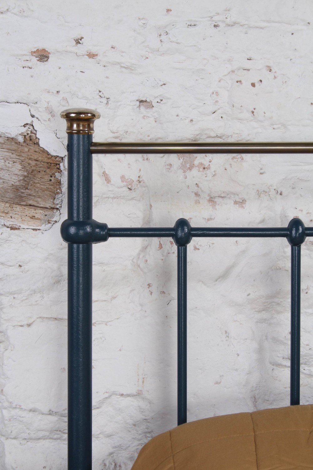 An Edwardian super king bedstead featuring a dark blue cast iron frame with vertical spindles and polished brass top rails. View VIII