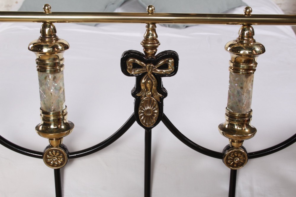 A Victorian black cast iron double bed frame with brass top rails, brass finials, and mother-of-pearl inlay details. View III