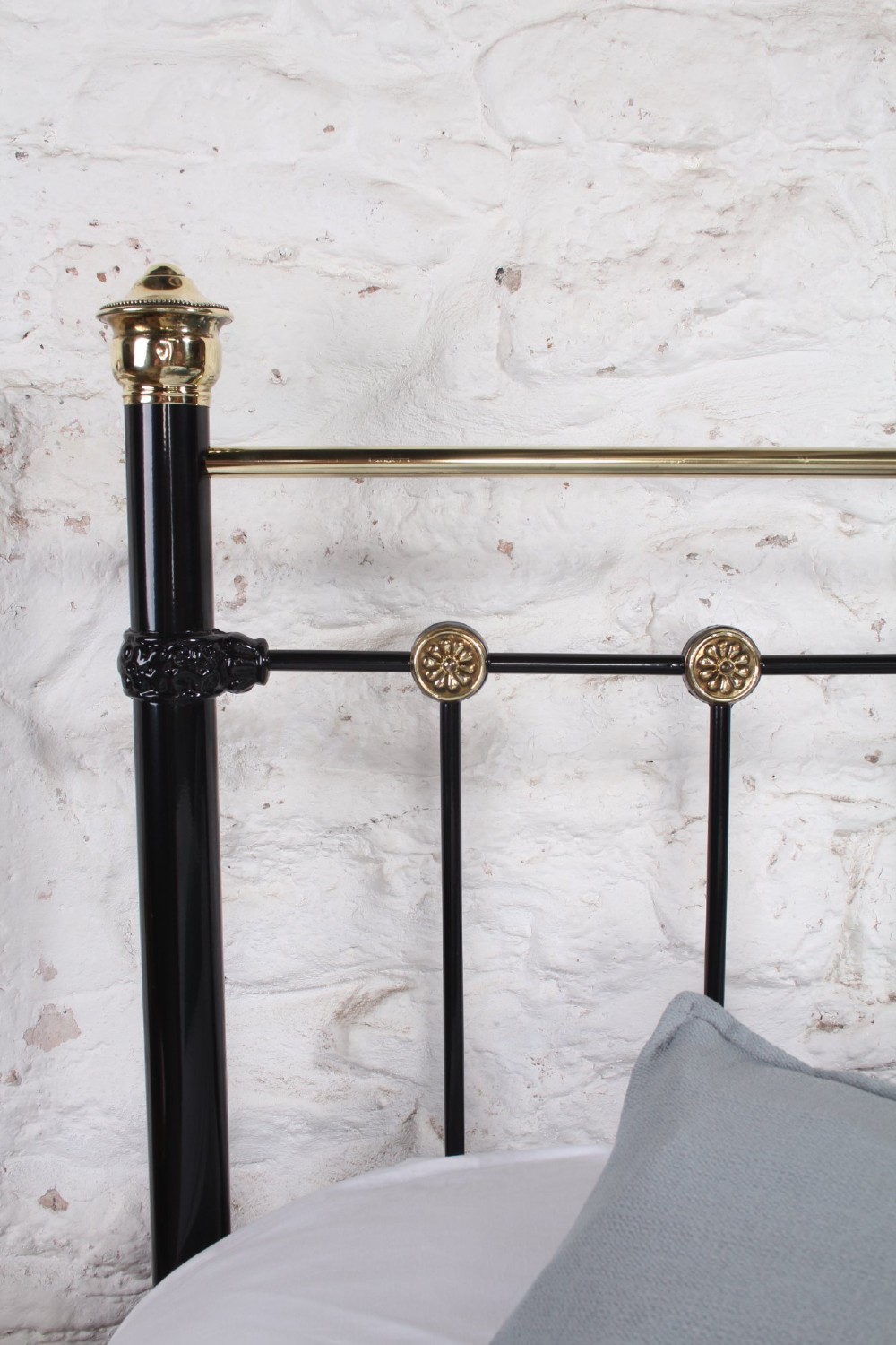 A Victorian black cast iron double bed frame with brass top rails, brass finials, and mother-of-pearl inlay details. View VII