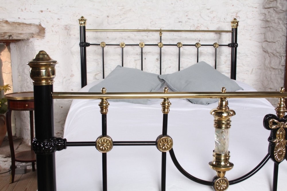 A Victorian black cast iron double bed frame with brass top rails, brass finials, and mother-of-pearl inlay details. View VIII