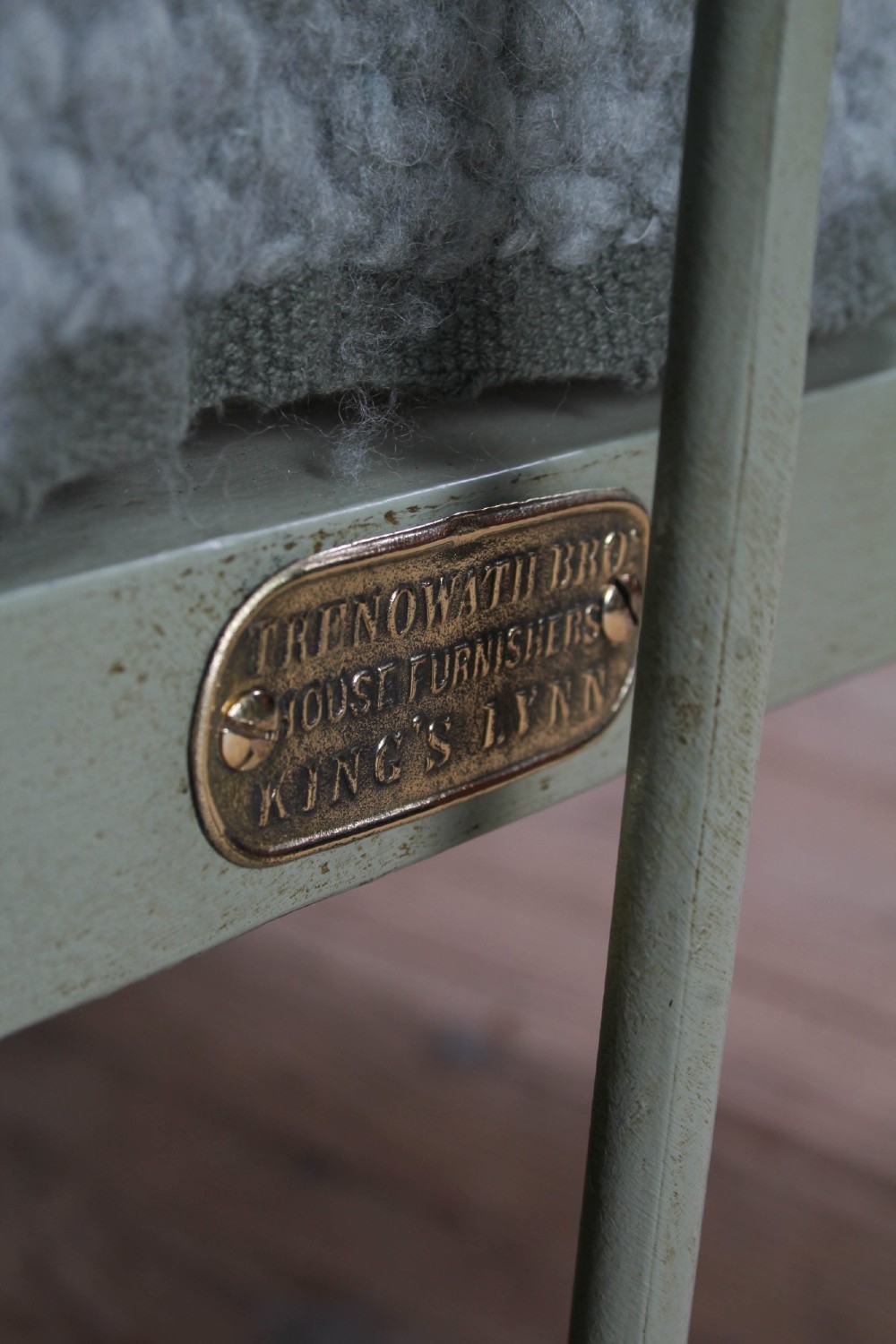 A Victorian sage green painted iron double bedstead featuring decorative scrollwork and polished brass top rails with spherical finials. View VII