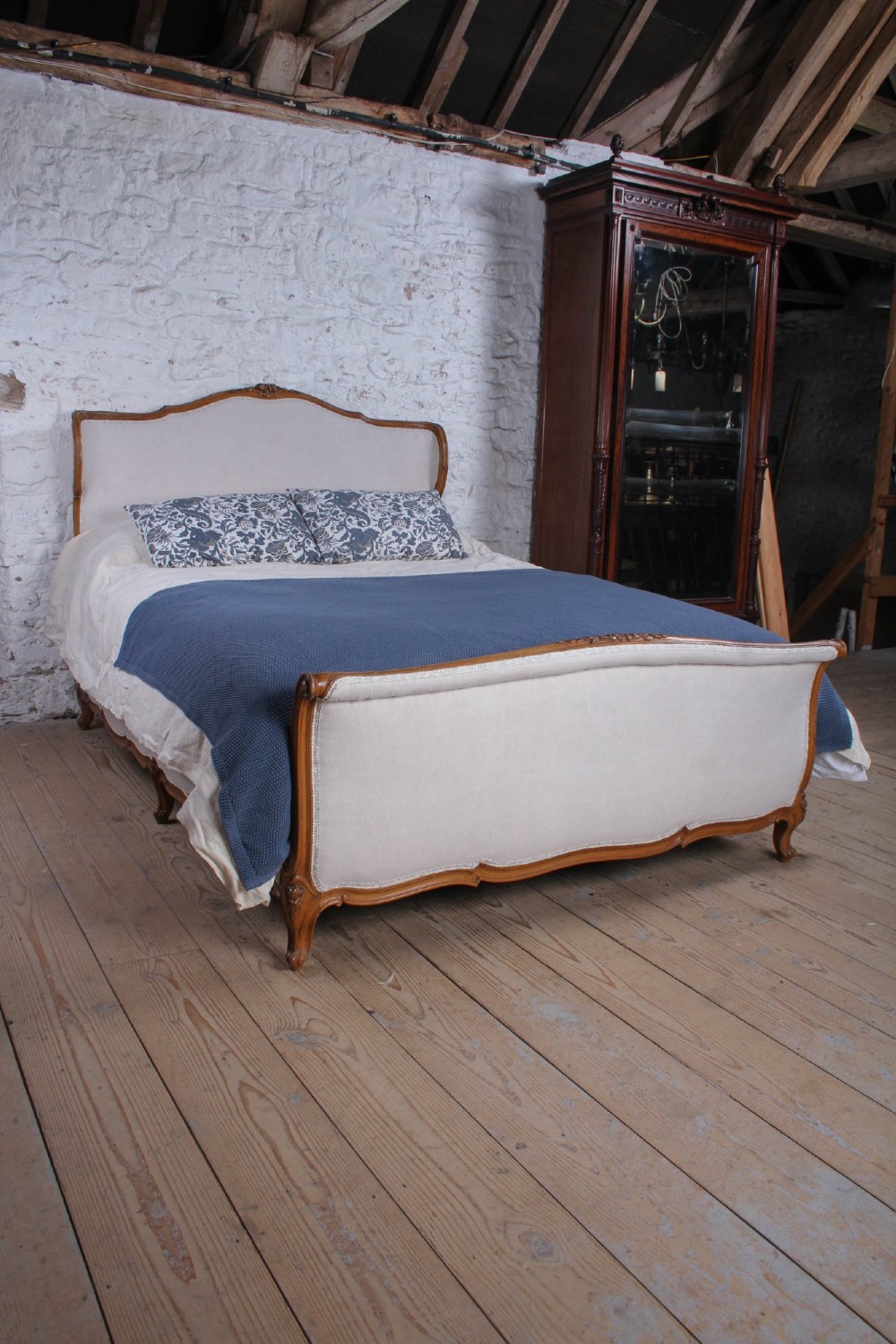 A Louis XV style king-size bed frame featuring a carved wooden structure, cabriole feet, and neutral upholstered headboard and footboard panels. View II