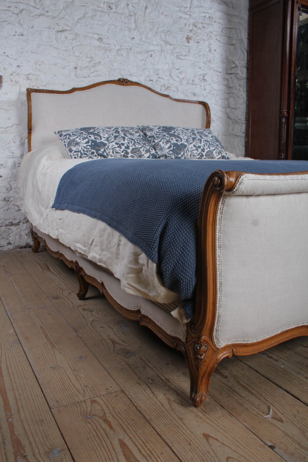 A Louis XV style king-size bed frame featuring a carved wooden structure, cabriole feet, and neutral upholstered headboard and footboard panels. View V