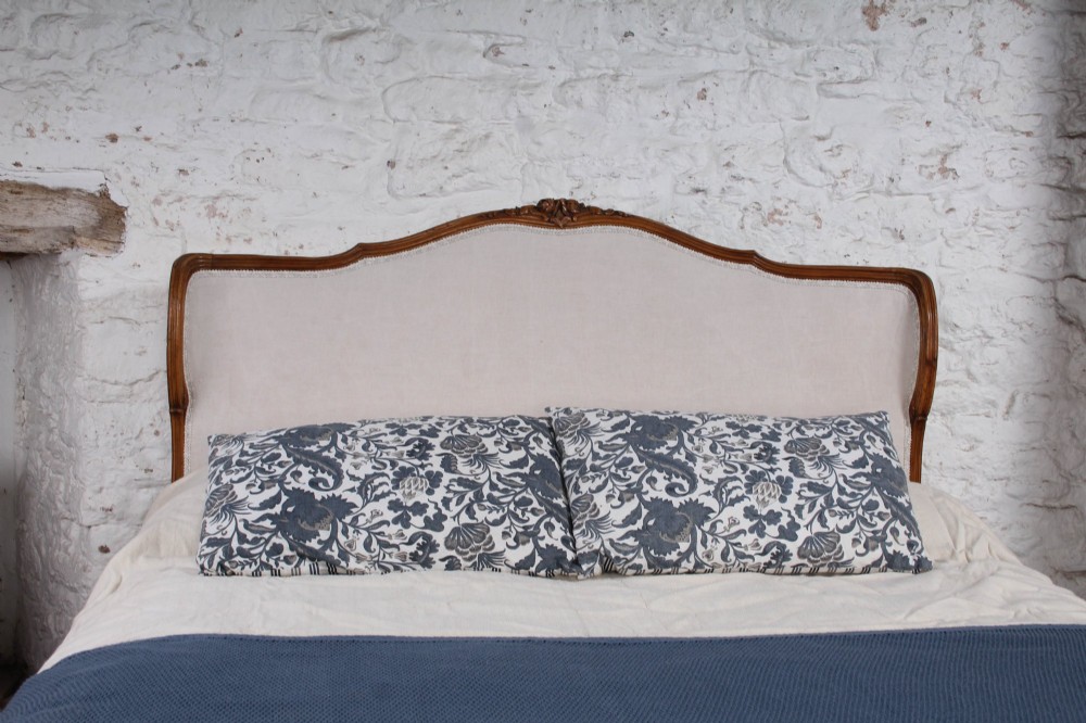 A Louis XV style king-size bed frame featuring a carved wooden structure, cabriole feet, and neutral upholstered headboard and footboard panels. View VI