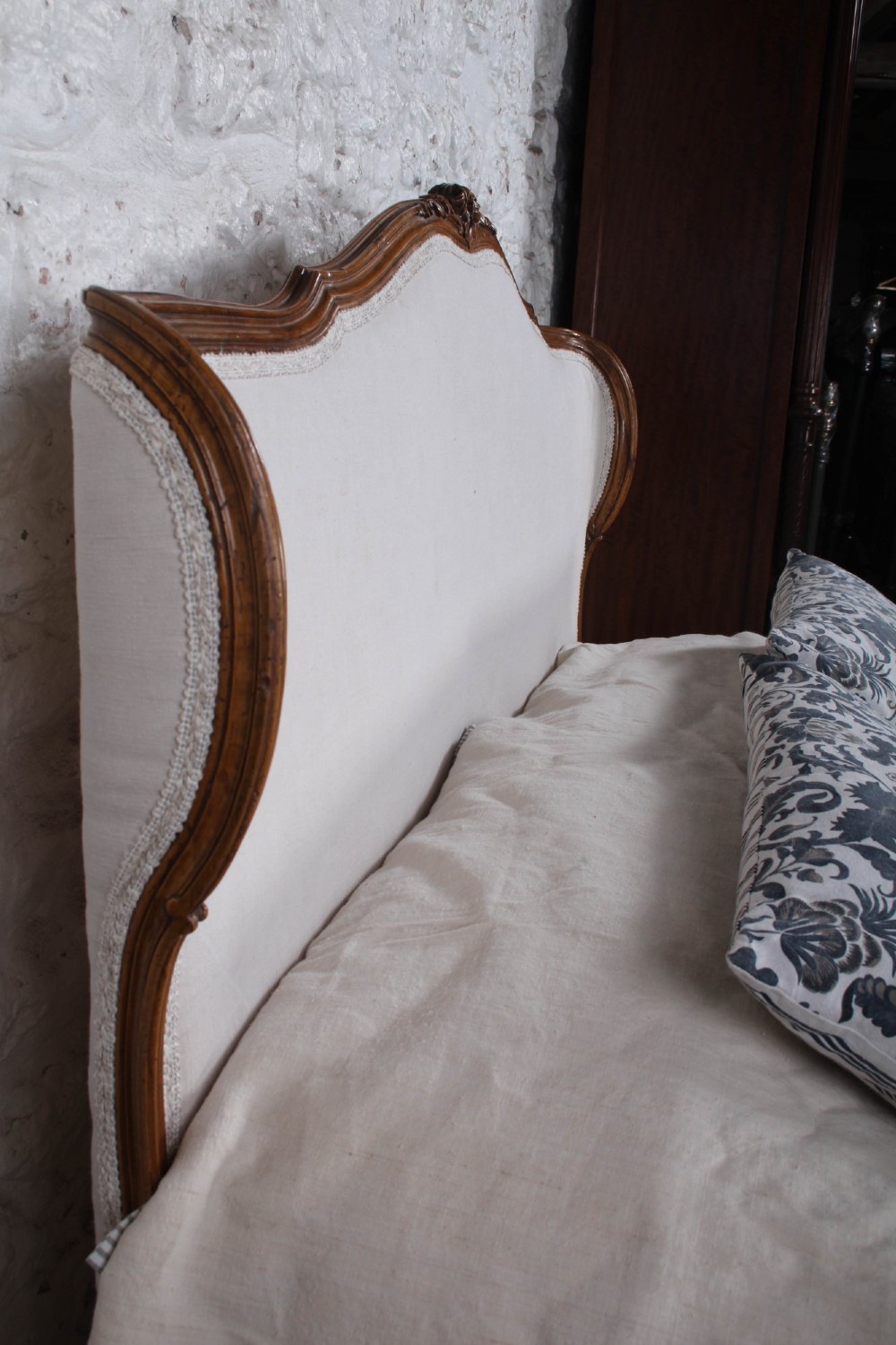 A Louis XV style king-size bed frame featuring a carved wooden structure, cabriole feet, and neutral upholstered headboard and footboard panels. View VII
