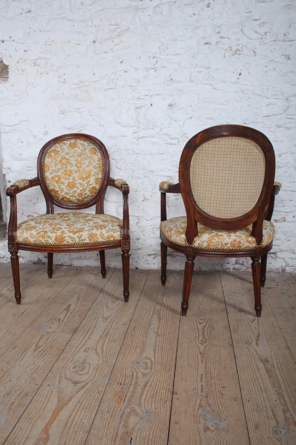 A pair of Louis XVI style carved timber armchairs with oval medallion backs and floral patterned upholstery. View IV