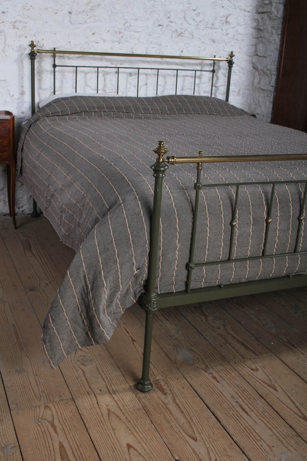 A dark green painted iron and brass king-size bedstead featuring vertical iron spindles and polished brass top rails. View IX