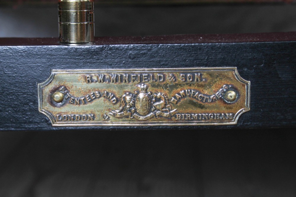 A Victorian iron and brass king-size bedstead featuring barley twist posts, ornate brass scrollwork on the footboard, and a arched black iron headboard. View III