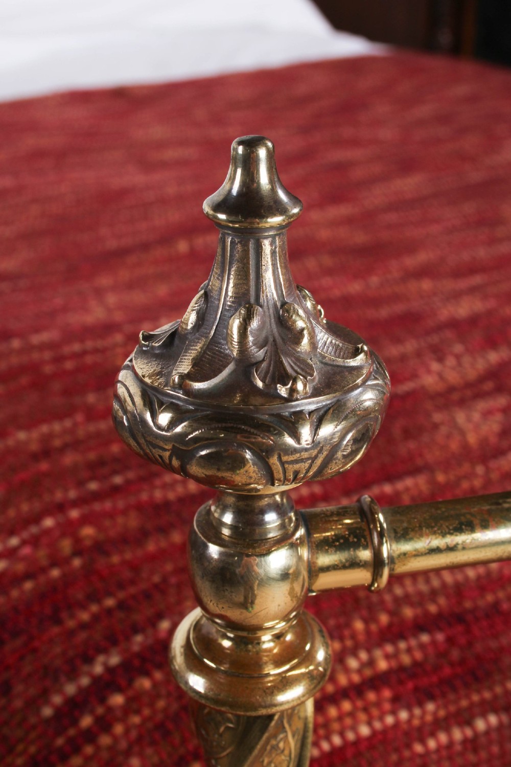 A Victorian iron and brass king-size bedstead featuring barley twist posts, ornate brass scrollwork on the footboard, and a arched black iron headboard. View XII