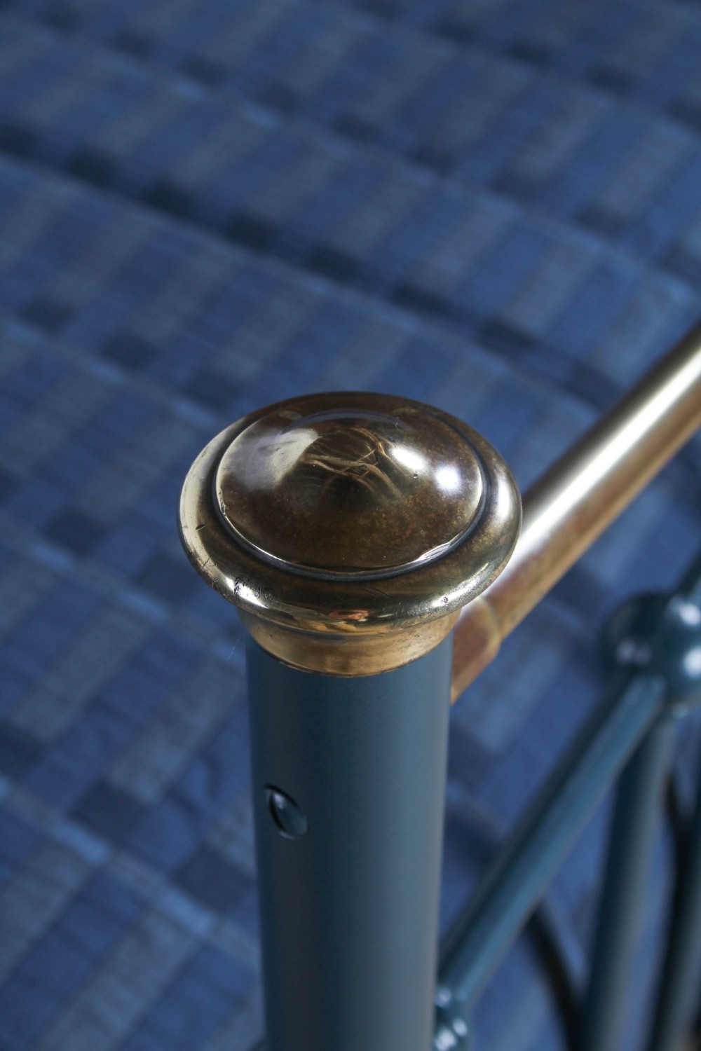 An Edwardian dark blue painted iron double bed frame featuring curved brass dip rails, vertical spindles, and ceramic castors. View VII