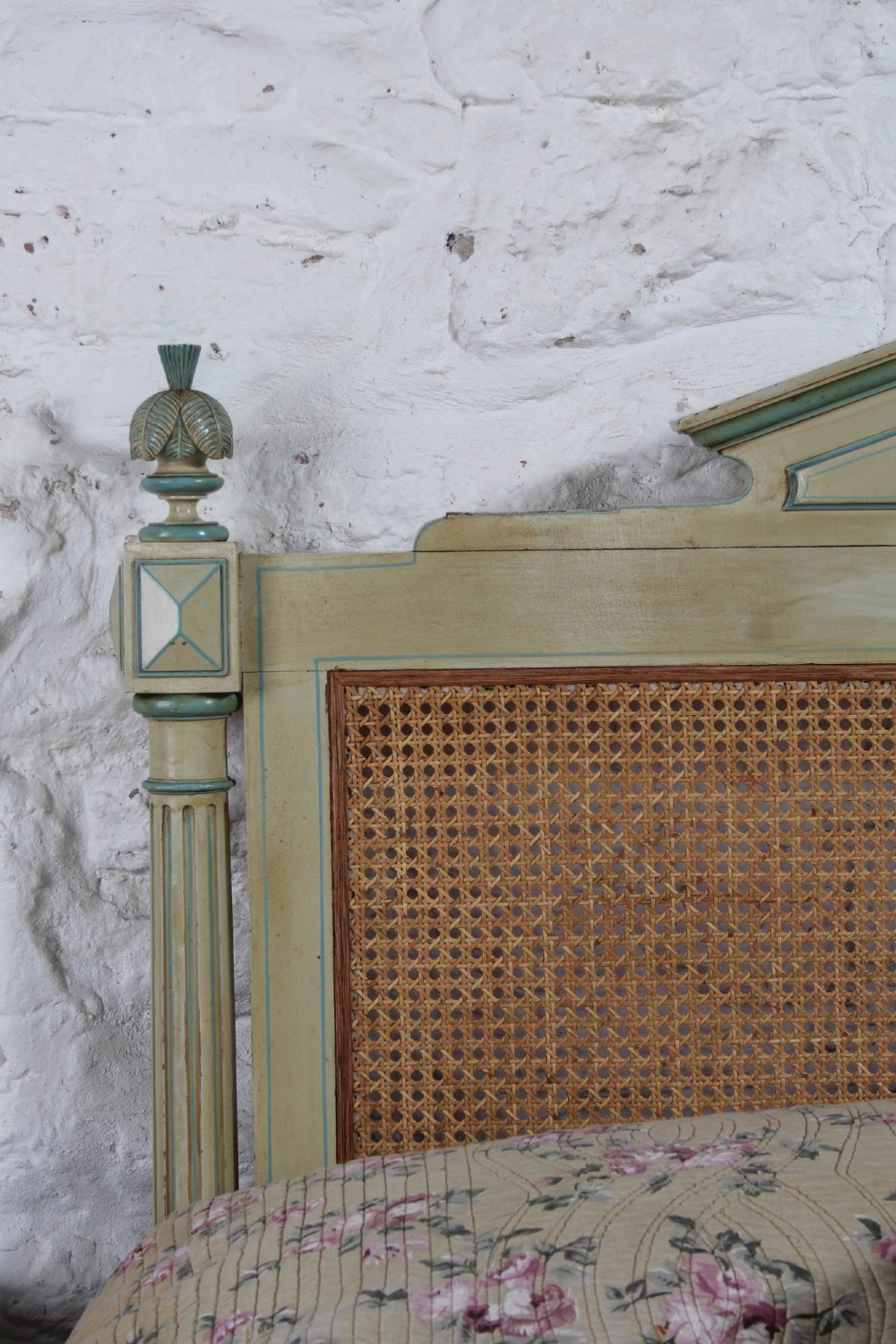 An Empire style bed frame with sage green painted timber, woven cane panels on the headboard and footboard, and carved corner finials. View VII