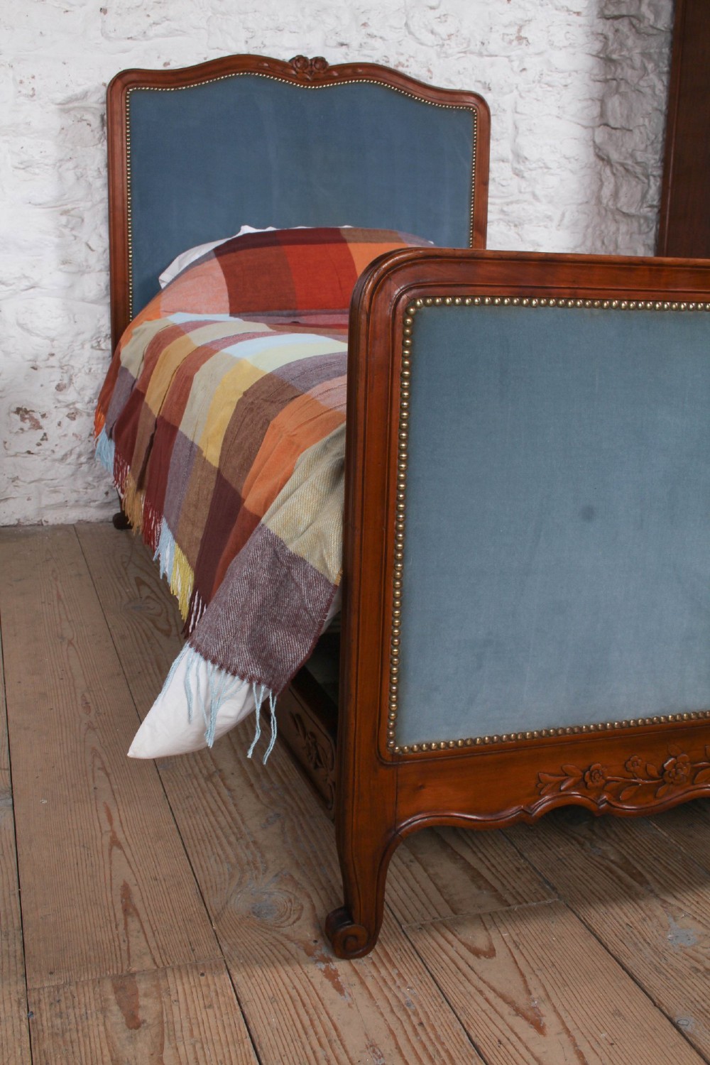A French Provincial style single bed featuring a carved timber frame with blue velvet upholstered headboard and footboard panels. View VIII