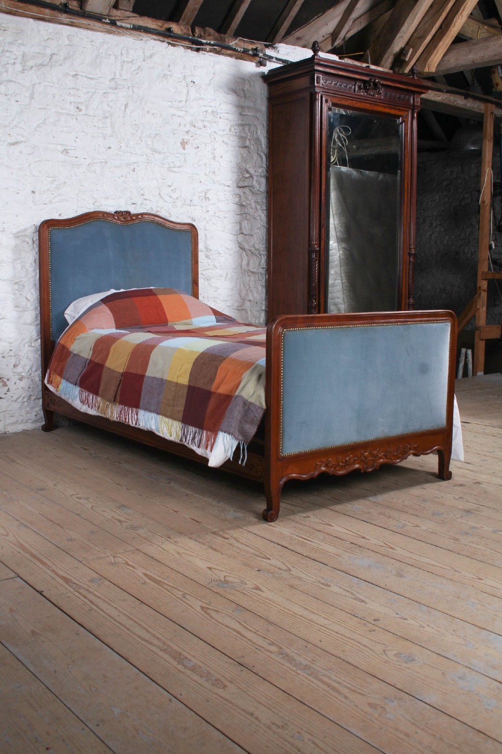 A French Provincial style single bed featuring a carved timber frame with blue velvet upholstered headboard and footboard panels. View IX