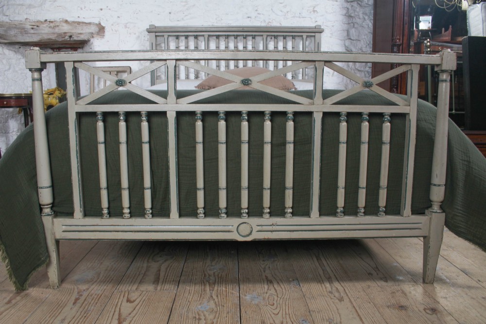 A grey painted French Arts and Crafts double bedstead featuring vertical spindle detailing and a patterned footboard. View III