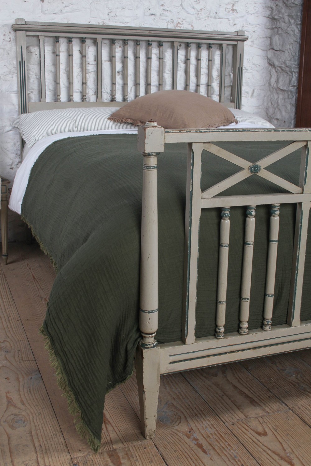A grey painted French Arts and Crafts double bedstead featuring vertical spindle detailing and a patterned footboard. View V