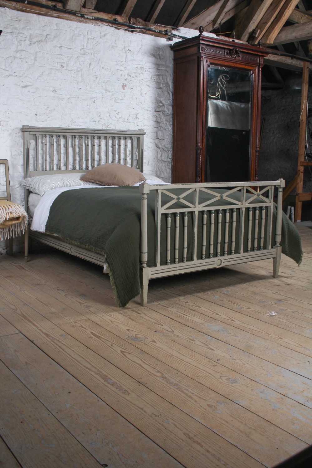 A grey painted French Arts and Crafts double bedstead featuring vertical spindle detailing and a patterned footboard. View X