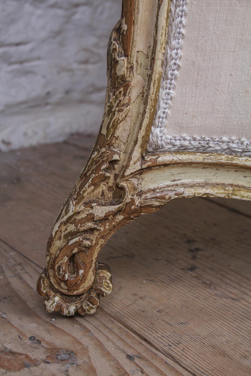 A three-panel Louis XV style folding dressing screen featuring carved cream painted timber frames with glass upper apertures and upholstered lower panels. View V
