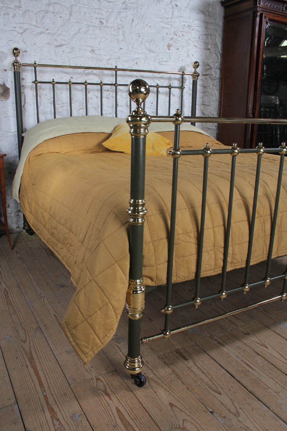 Victorian super-king size bedstead featuring dark green painted iron spindles and polished brass rails and finials. View II