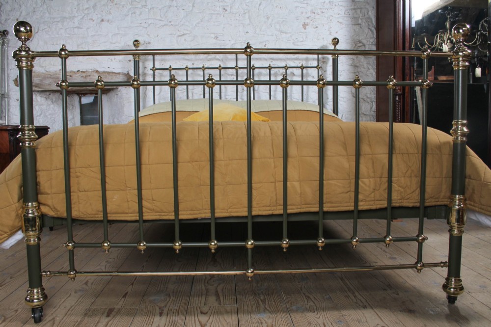 Victorian super-king size bedstead featuring dark green painted iron spindles and polished brass rails and finials. View IV