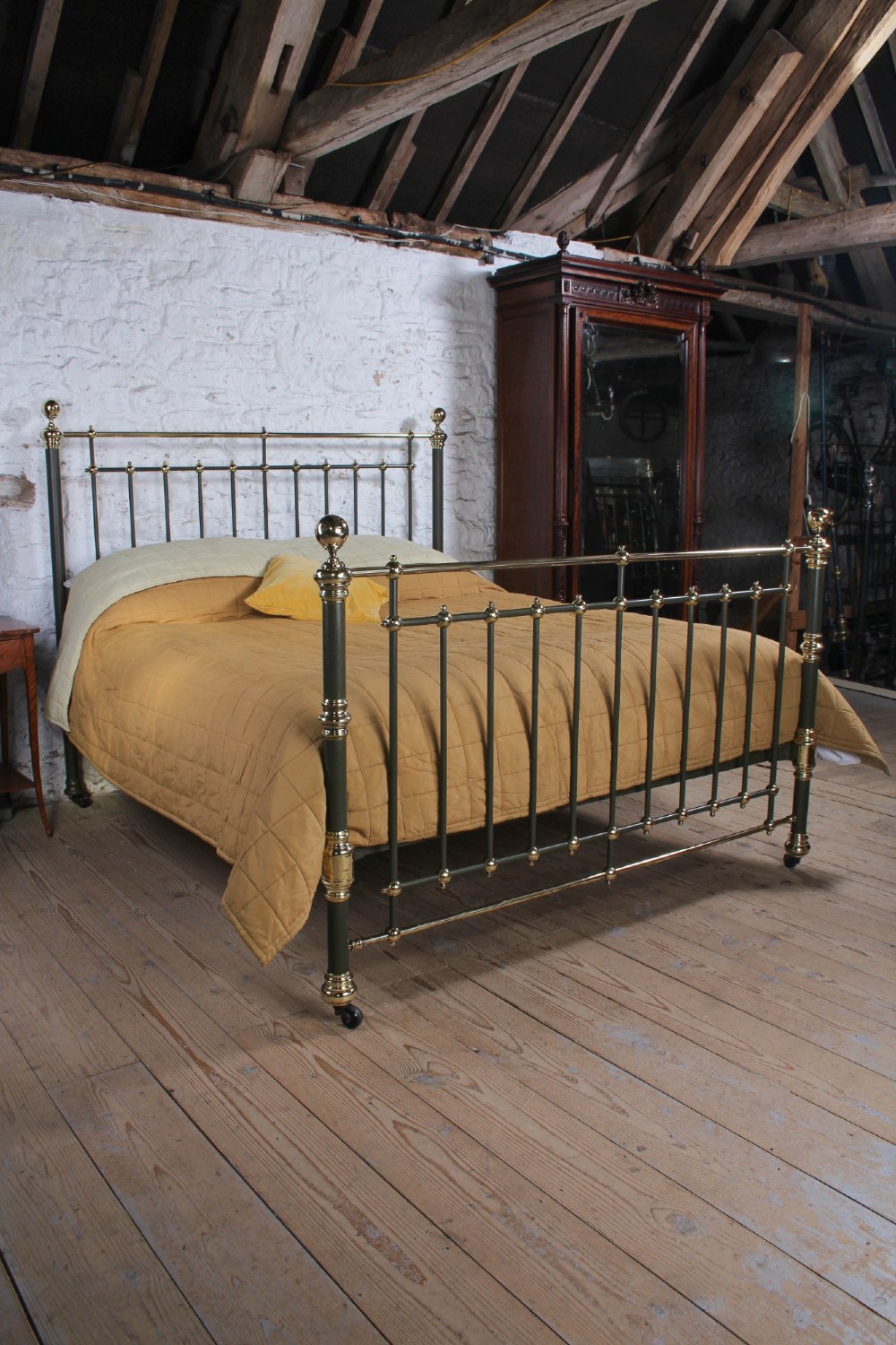 Victorian super-king size bedstead featuring dark green painted iron spindles and polished brass rails and finials. View IX