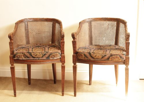 A Pair of Walnut Canned Arm Chairs
