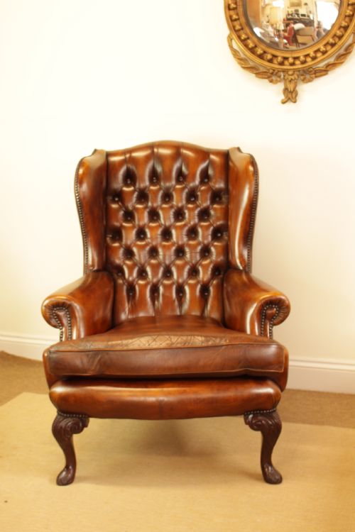 A Button Back Leather Wing Arm Chair