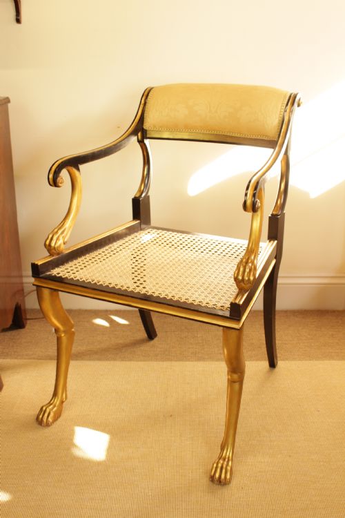 A Gilt & Ebonies Cane Open Arm Chair