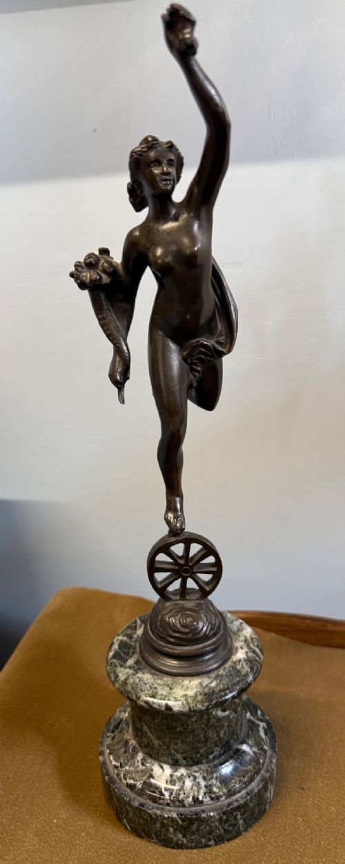 A pair of dark bronze Neoclassical figures depicting Mercury and Fortuna mounted on cylindrical green marble pedestals. View II