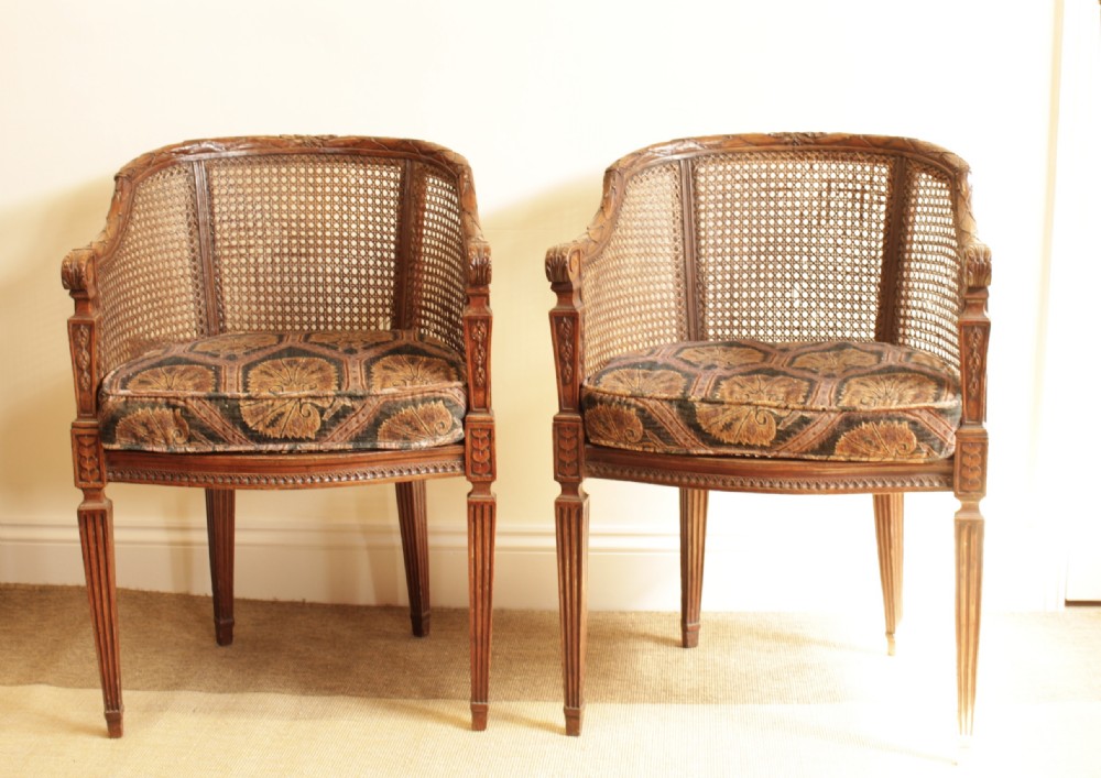 A Pair of Walnut Canned Arm Chairs