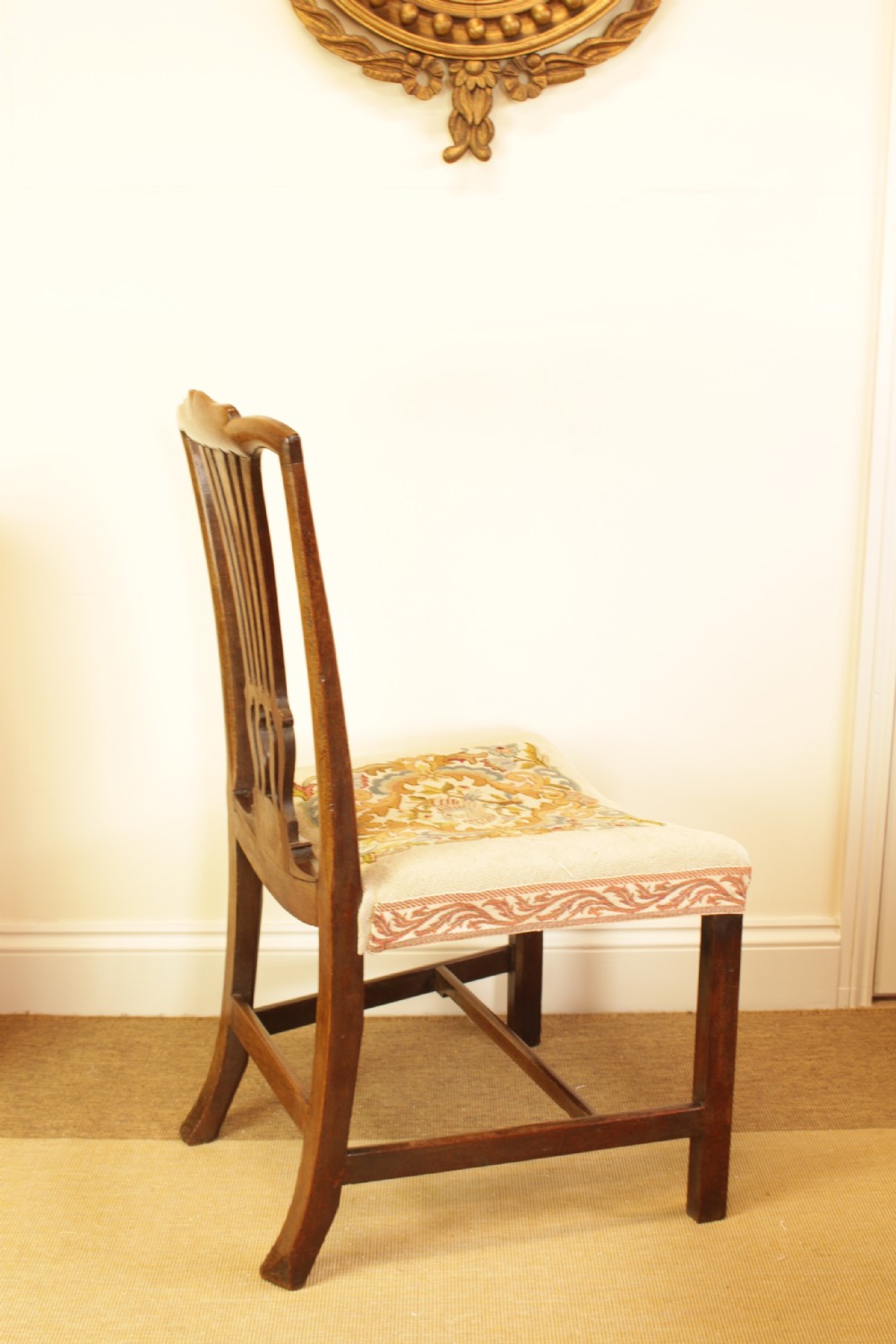 An antique mahogany side chair featuring a carved pierced splat back and a floral needlepoint upholstered seat. View II