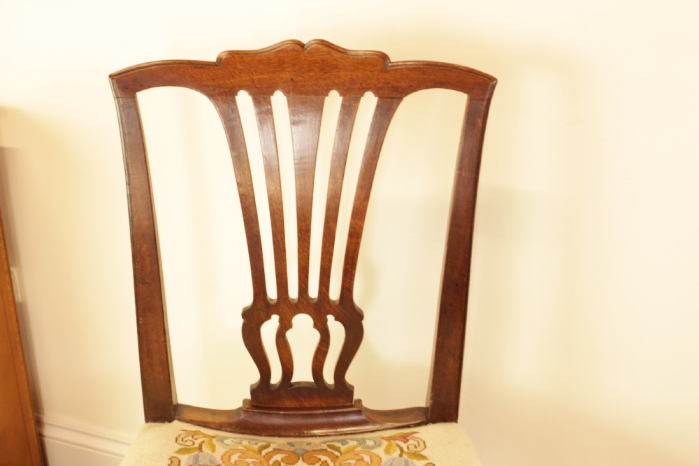 An antique mahogany side chair featuring a carved pierced splat back and a floral needlepoint upholstered seat. View III