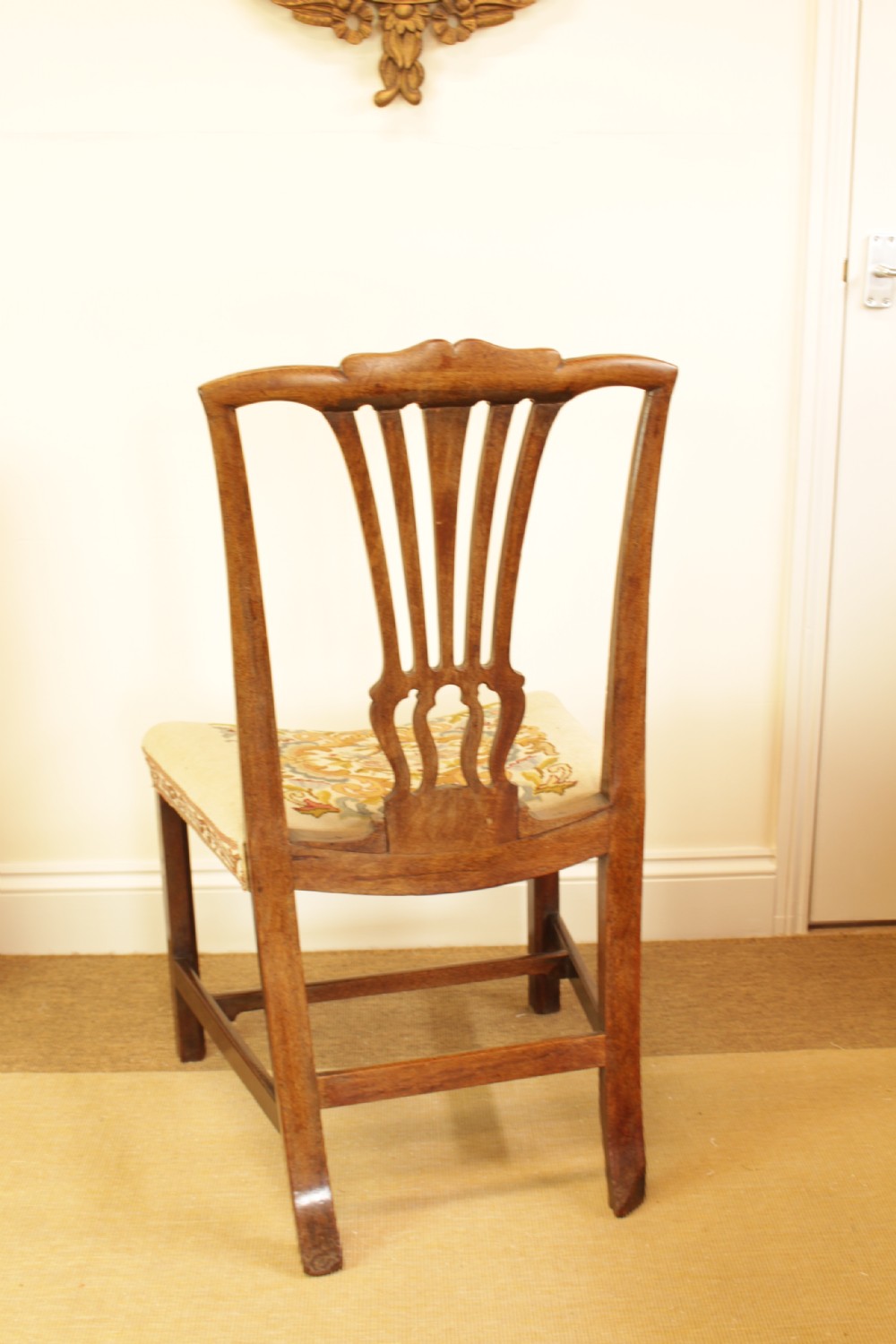 An antique mahogany side chair featuring a carved pierced splat back and a floral needlepoint upholstered seat. View V