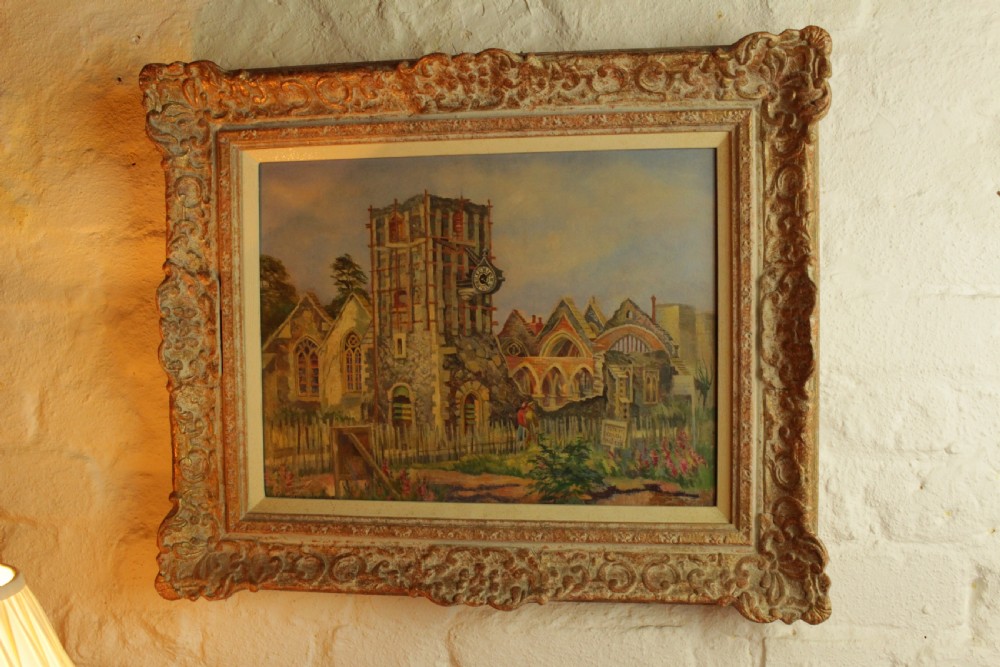 An architectural oil painting on board depicting Saint George Church in Canterbury, housed within a heavily ornate swept gilt frame.