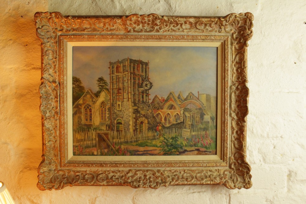 An architectural oil painting on board depicting Saint George Church in Canterbury, housed within a heavily ornate swept gilt frame. View II