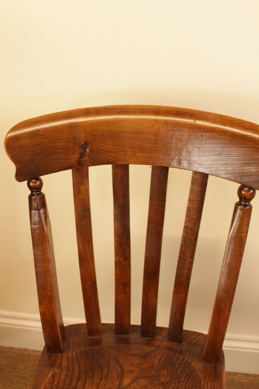 Set of four dark-stained wooden kitchen chairs featuring shaped elm seats, turned legs, and backrest spindles with curved top crest rails. View IV