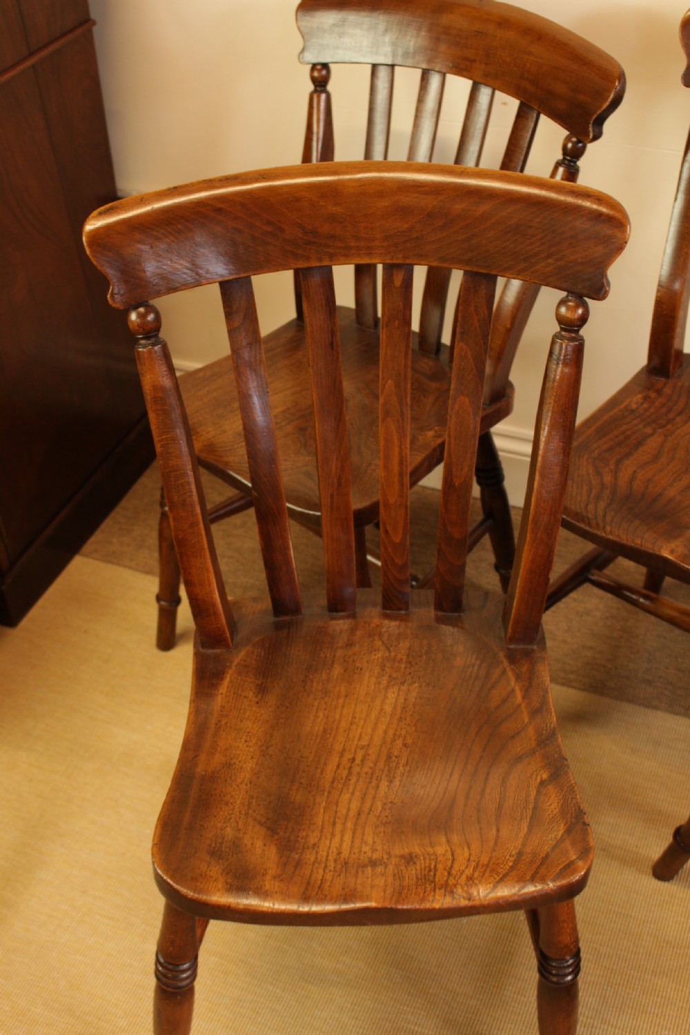 Set of four dark-stained wooden kitchen chairs featuring shaped elm seats, turned legs, and backrest spindles with curved top crest rails. View IX